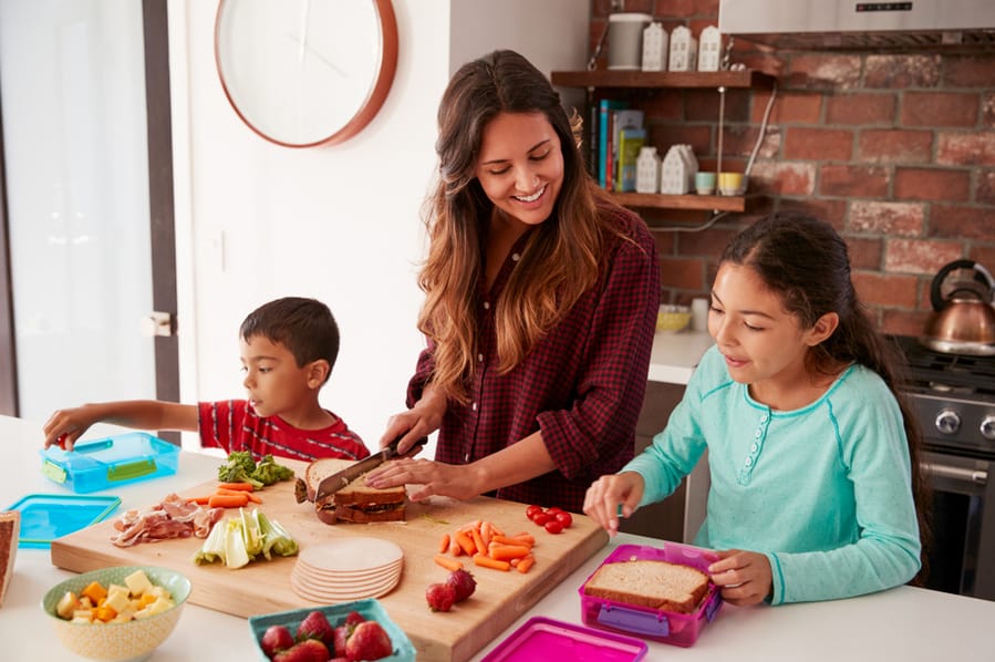 Mother And Children Packing Their Own Meals