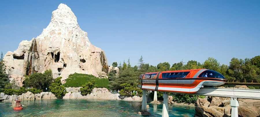 The Monorail From Tomorrowland Station With The Matterhorn In The Background.