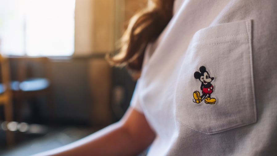 A Woman Wearing A Mickey Mouse White T-Shirt