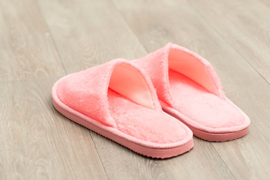 Pair Of Pink Slippers On Wooden Floor