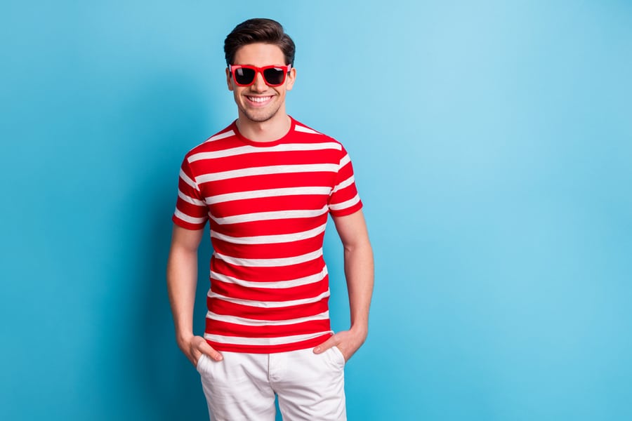 Photo Portrait Of Young Man Smiling Wearing Stylish Sunglass Striped T-Shirt Shots Isolated On Vivid Blue Color Background