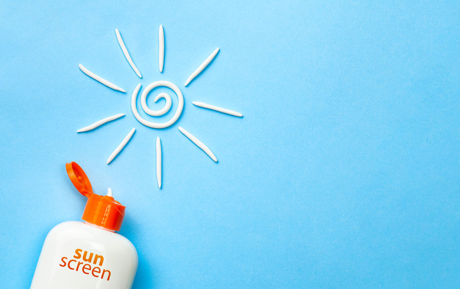 Sunscreen. Cream In The Form Of Sun On Blue Background With White Tube. Copy