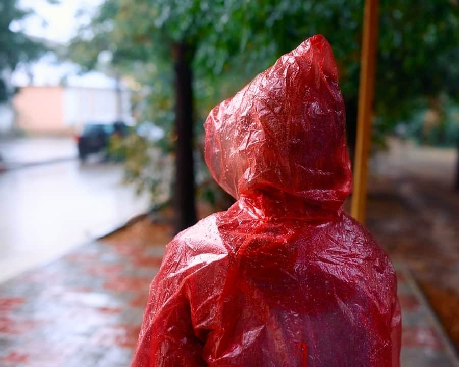 Woman In The Rain In A Raincoat