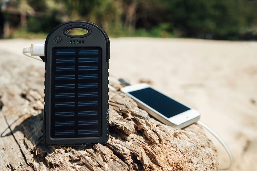 Battery Solar Energy Device On A Background Of The Sandy Beach