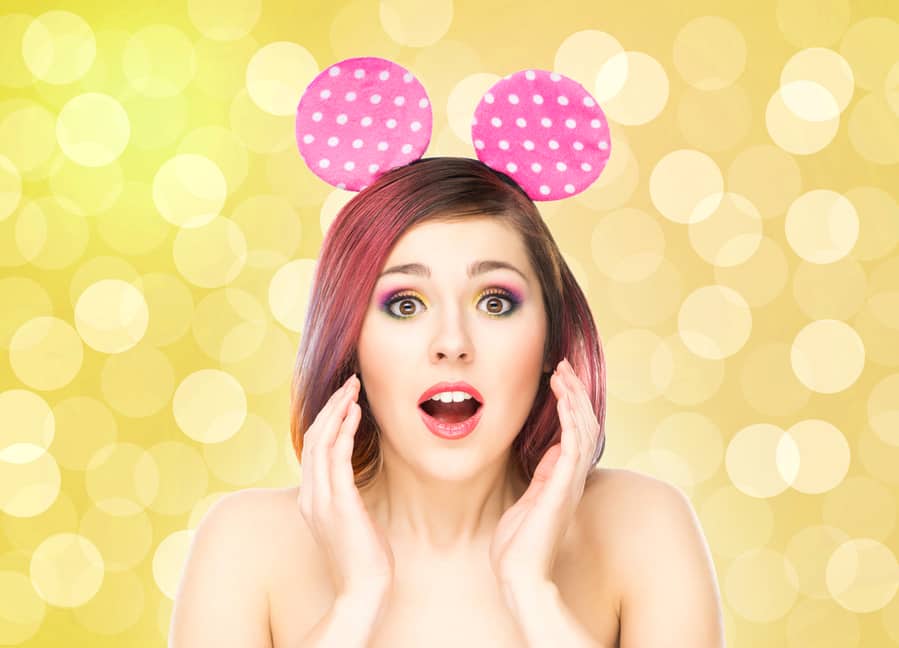 Beautiful Young Smiling Woman In Mickey Mouse Ears On Bubble Background