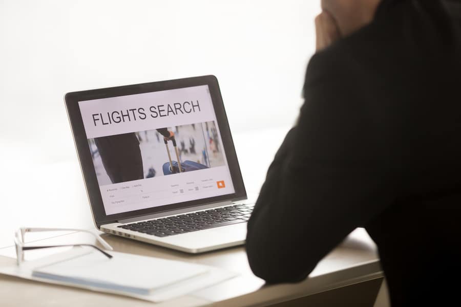 Businessman Using Laptop For Searching Cheap Low Cost Business Flight, Choosing Airfare Deal