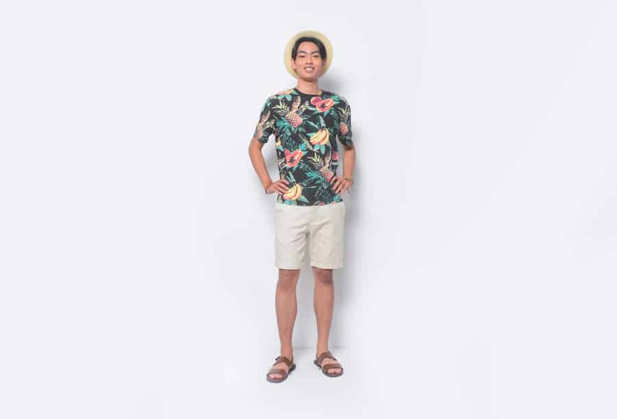 Full Body Man Casual Summer Wearing New Stylish Fruit Printed T-Shirts With Khaki Pants Shorts And Flip Flop With Hands Holds Pockets Standing