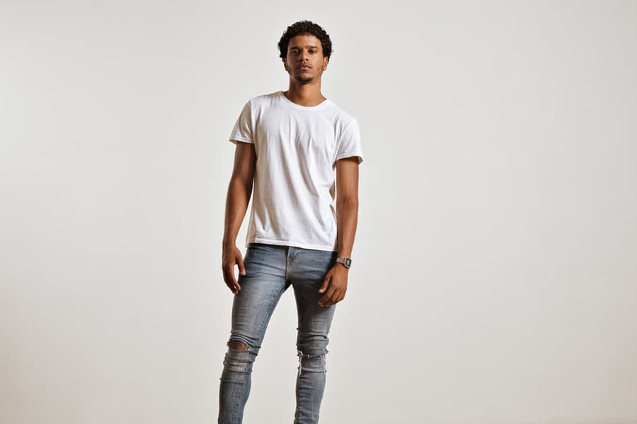 Full-Body Shot Of An Athletic Attractive Young Male In Ripped Light Blue Jeans And Blank White Shortsleeve T-Shirt