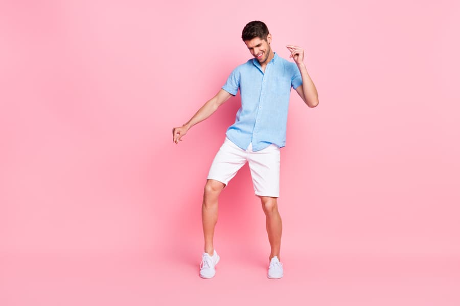 Full Length Body Size Photo Smiling Man In Blue Shirt Dancing At Party Isolated Pastel Pink Color Background