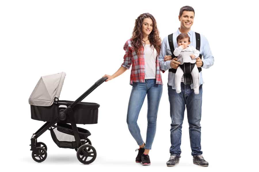 Full Length Portrait Of A Young Mother With A Stroller And A Father With A Baby In A Carrier Isolated On White Background