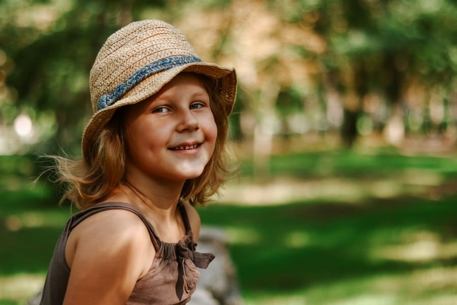 Girl In A Straw Hat Outdoors