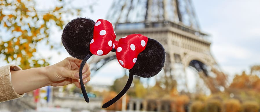 Minnie Mouse Ears In Female Hand On Embankment Near Eiffel Tower In Paris