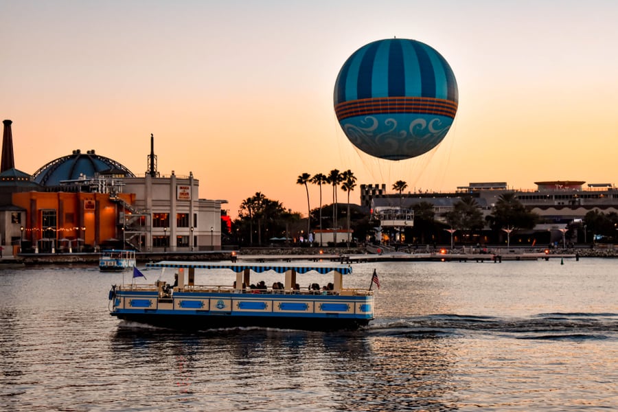 Panoramic View Of Disney Springs And Water Taxi On Colorful Sunset Background At Lake Buena Vista Area