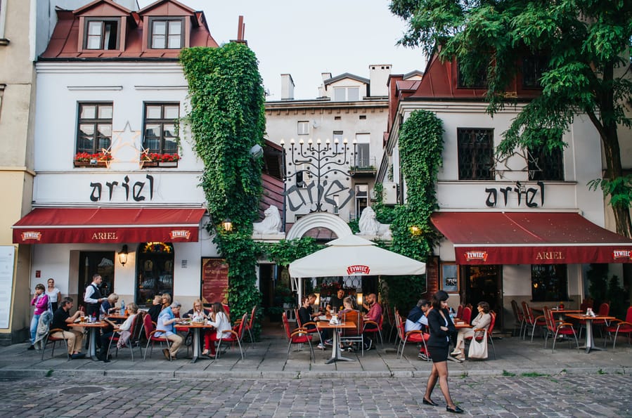 People Enjoy Their Meals In Atmospheric Cafe In Jewish Quarter
