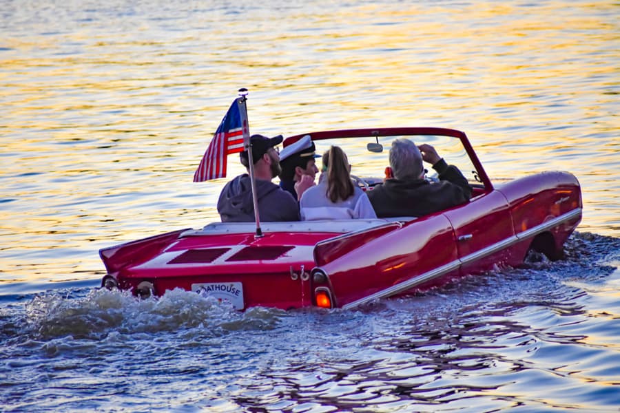 People Enjoying Ride In Red Amphibious Car At Lake Buena Vista Area (