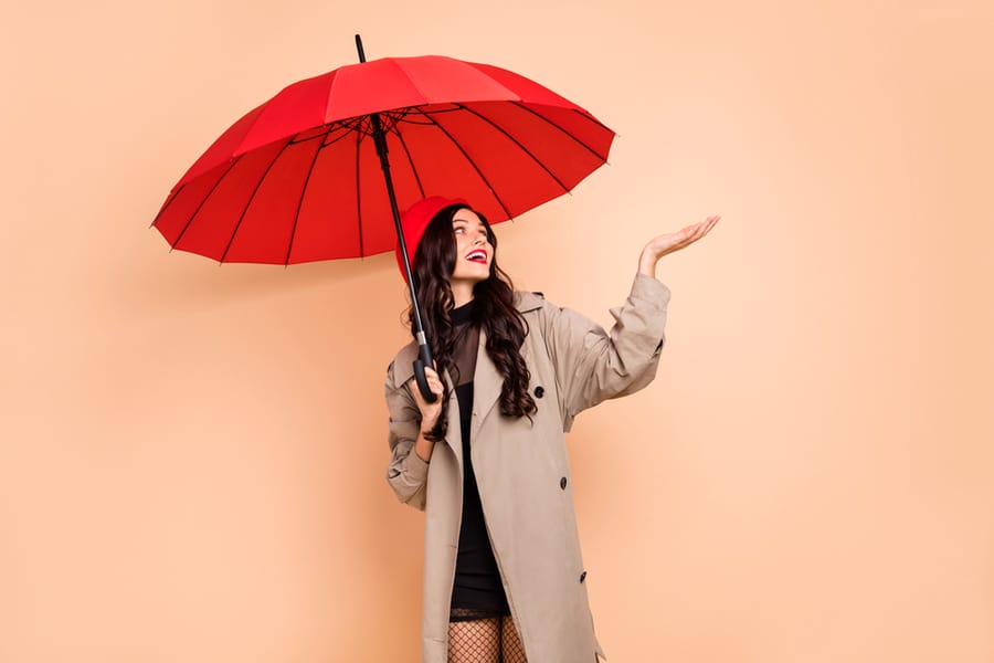Photo Of Attractive Girl Hold Umbrella During A Rainy Weather Isolated On Beige Color Background