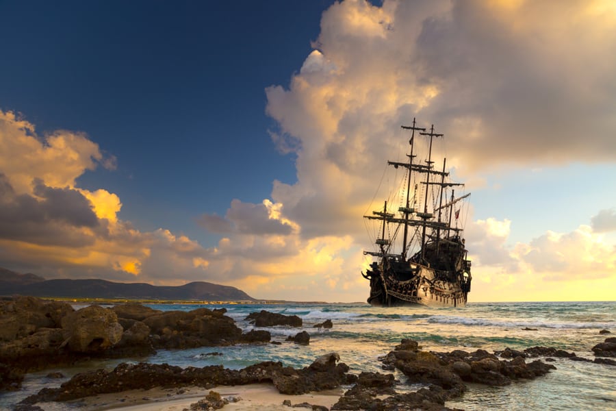 Pirate Ship At The Open Sea At The Sunset