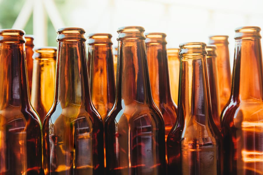 Several Brown Glass Bottles Seen From A Low Angle