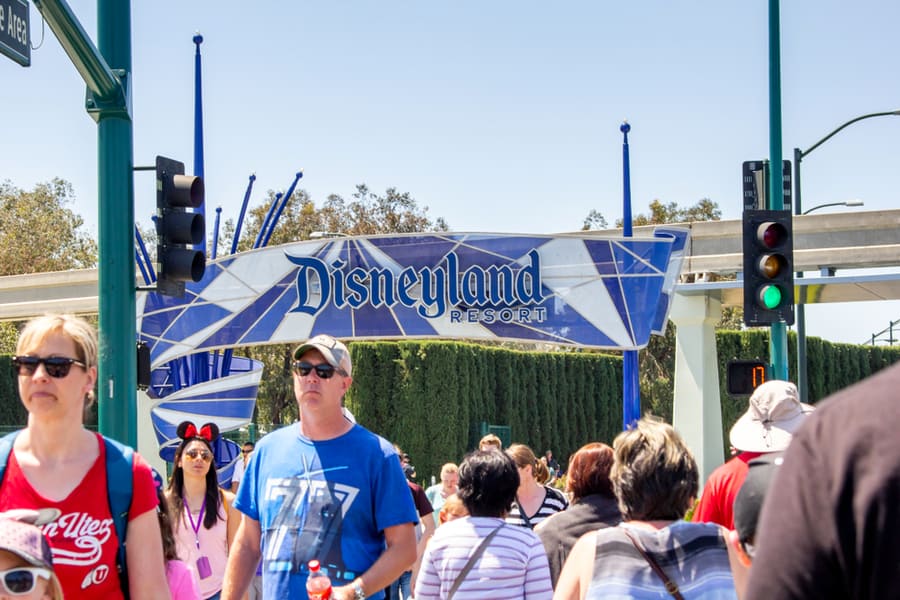 Tourist Walk Across The Street Towards Disneyland Theme Park