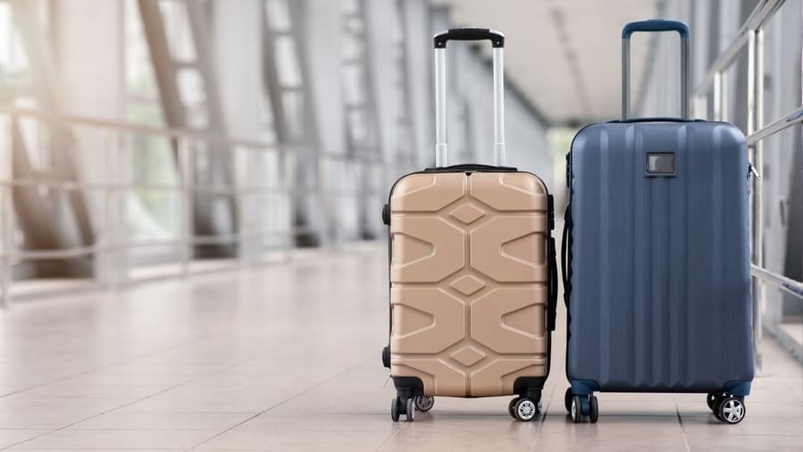 Two Stylish Suitcases Standing In Empty Airport Hall